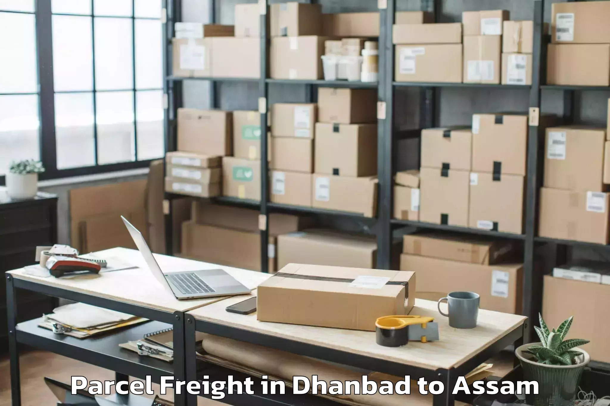 Leading Dhanbad to Kalaigaon Parcel Freight Provider